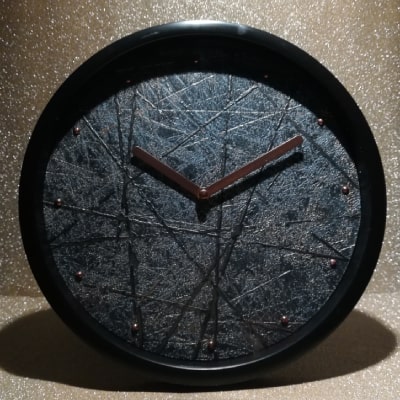 L'orologio moderno nero con linee intersecate color rame effetto metallo in rilievo è un pezzo unico nell'home decor. La tonalità nera aggiunge eleganza, mentre le linee color rame conferiscono lusso, creando uno stile sofisticato e contemporaneo.